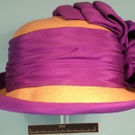 Cloche straw hat with purple silk ribbon decoaration.